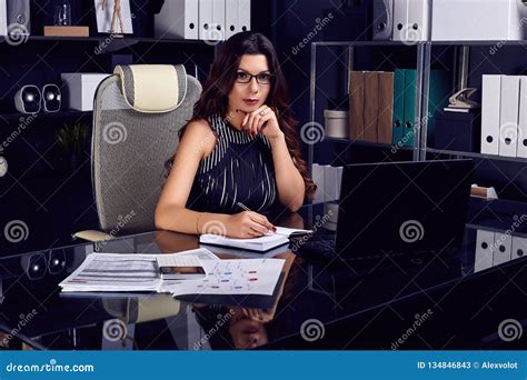 Young Beautiful Business Woman Working At Stylish Black Desk Stock