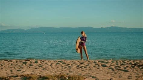 Young Attractive Female Surfer With Her Surfboard At Sunset On The Beach Stock Video Video Of