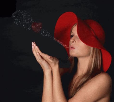 A Woman Wearing A Red Hat Blowing Bubbles