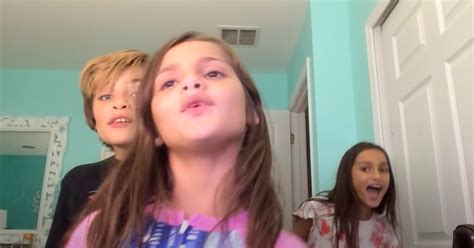 siblings sneak up behind little sister singing and dancing