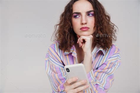 Image Of Ginger Brooding Woman Thinking And Using Smartphone Stock