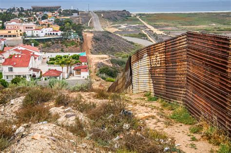 The Degraded Iron Wall Along The Usmexico Border In Tijuana Beach In