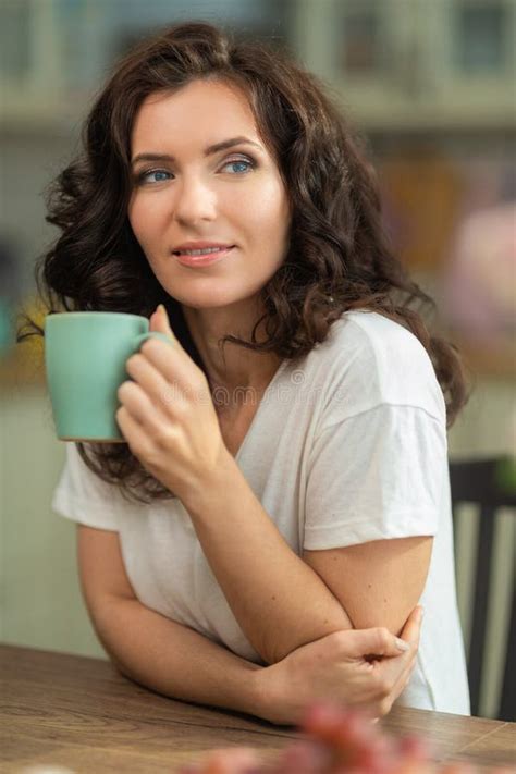 Brunette Woman Housewife In White T Shirt And Jeans At Home In The Interior Stock Image Image