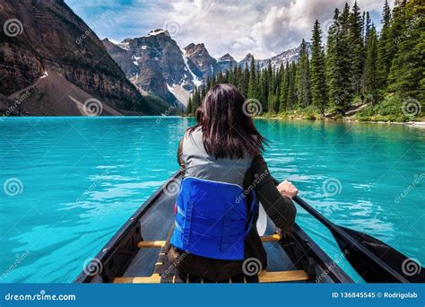 Tourist Canoeing On Moraine Lake In Banff National Park Canadian