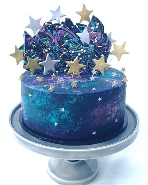 To make my galaxy mega cake, i began by caking 10lbs of my ultimate vanilla cake but dyed each a marbled bright colour. A galaxy themed cake for the opening of @the_craft_parlour ...