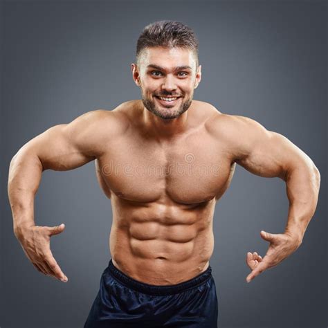 Strong Athletic Man Fitness Model Torso Pointing Down Stock Photo