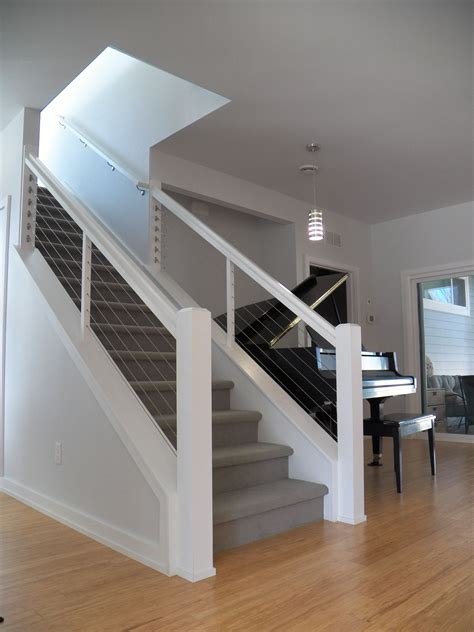 Cable railings (also known as cable railing systems and wire rope railings) are a low maintenance alternative to traditional wood or metal railings. Staircase with steel cable and wood railings. Bentonville, Arkansas. | Stair remodel, Staircase ...