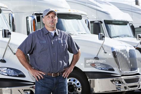 Truck Driver Standing In Front Of Big Rigs High Res Stock Photo Getty