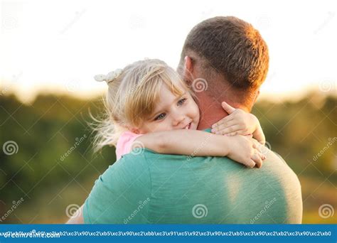 Little Daughter Hugs Father Tightly Around The Neck Stock Photo Image