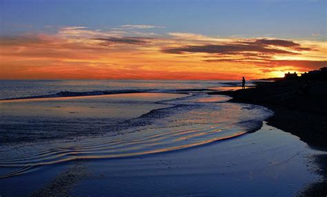 You know what they say about red sails in the morning? Sunset reflecting on beach at Emerald Isle, North Carolina Photograph by David Knowles