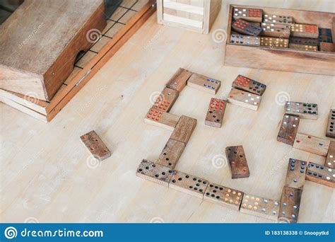 Playing Traditional Wooden Domino Game On Wooden Table Background