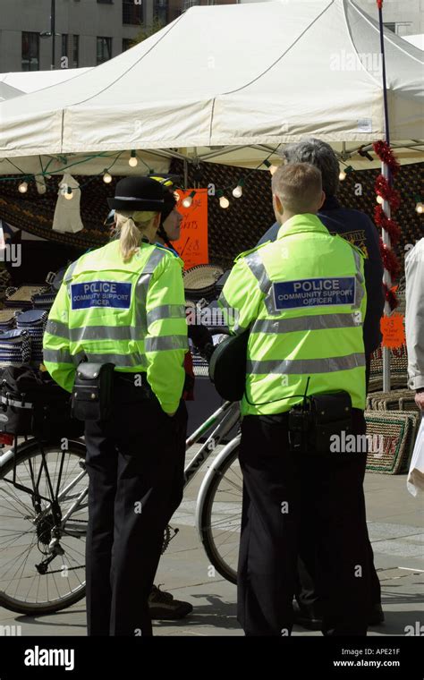 Police Community Support Officers Talking To A Member Of The Public At An Outdoor Event Stock