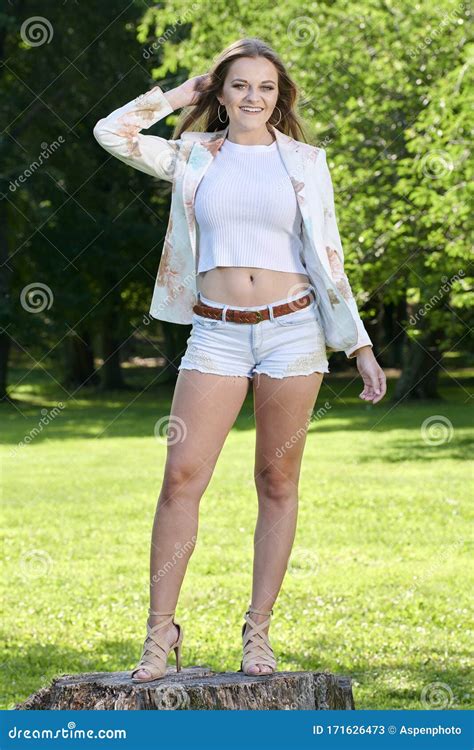 Woman Poses In Pastel Blazer And Denim Shorts Outdoors Stock Image