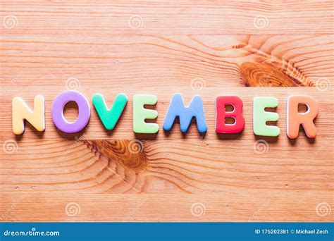 November Word Written With Colorful Letters On Wooden Background Stock
