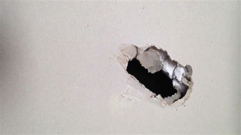 This assures the patch is covered even when the spackle shrinks during drying. How to Patch a Hole in Drywall