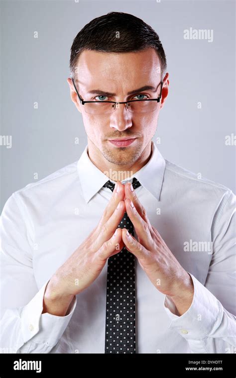 Confident Businessman Folding His Hands Together On Gray Background