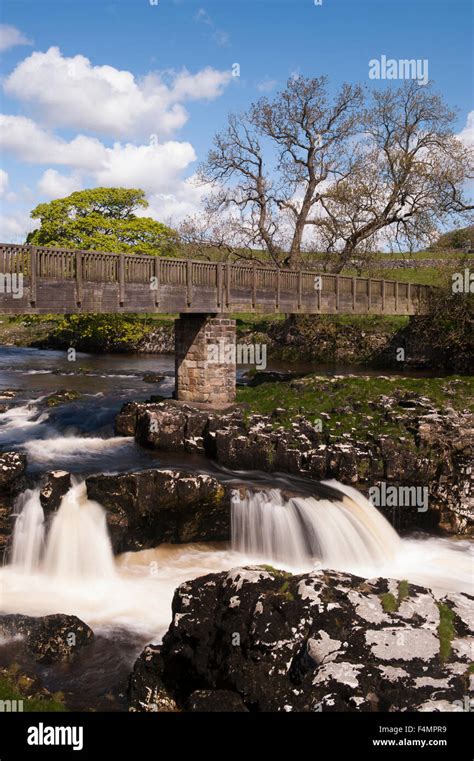 River Wharfe Flowing Slow Shutter Speed View Under Footbridge And Blue