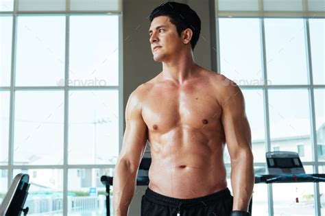Portrait Of Muscular Topless Man In Sportswear At Fitness Studio Stock