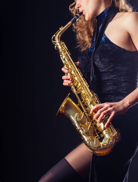 Saxophone Player Woman With Saxophone On A Dark Background Saxophone