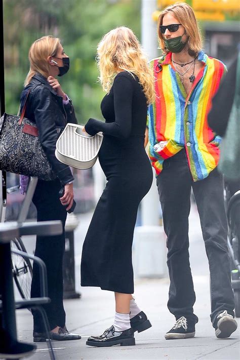 Elsa Hosk Shows Her Baby Bump In A Form Fitting Black Dress While Out
