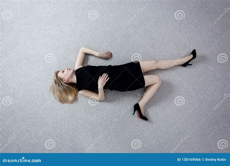 Beautiful Dead Woman In Black Dress Lying On The Floor Stock Photo