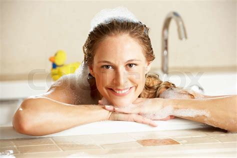 woman relaxing in bubble filled bath stock image colourbox
