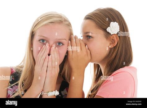 Teen Girls Are Whispering Gossip To Each Other Stock Photo Alamy