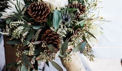 Rustic Winter Wedding Bouquet With White Roses Eucalyptus And Pine