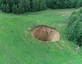 'GATE TO HELL' Terrified locals FRANTIC as giant hole appears in field ...