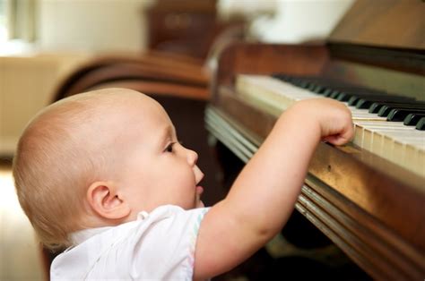 Premium Photo Cute Baby Playing On Piano