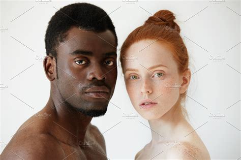 Black And White Headshot Of African Man And Caucasian Woman Standing