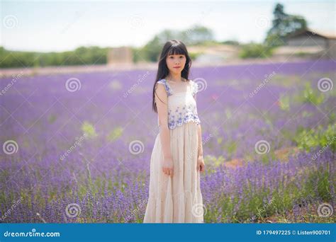 Young Chinese Woman In White Traditional Dress Walking In Lavender