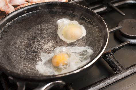 two eggs being poached in boiling water free stock image