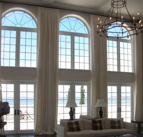 In most homes, a boring neutral shade is the default ceiling color — and we think that is a missed decorating opportunity. 20 Sumptuous Living Room Designs with Arched Windows - Rilane