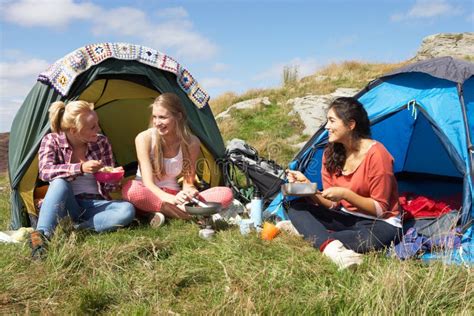 Group Of Teenage Girls On Camping Trip In Countryside Stock Photo