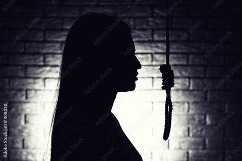 Silhouette Of Woman With Noose On Dark Background Suicide Concept