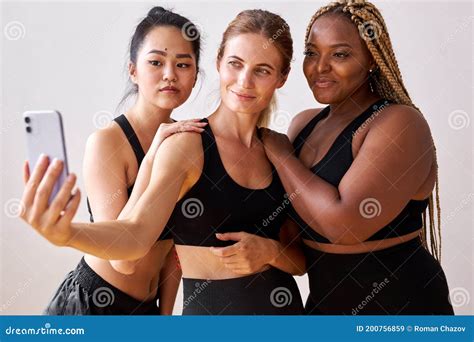 Three Young Multi Ethnic Female Models Of Different Race And Body Size Taking Selfie At Camera