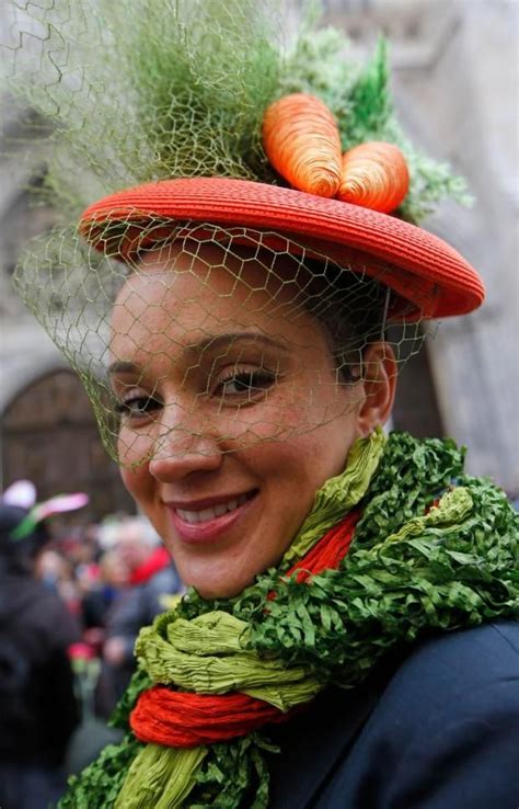 A Woman Sports Colorful Carrots On Her Hat And A Scarf Resembling Salad