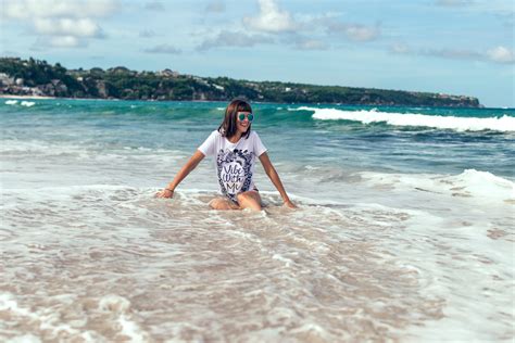 Free Photo Female Sitting On Beach Shore Wearing White Shirt Beach Sand Woman Free