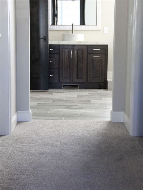 The mixed gray shades of the laminate flooring outside of the bedroom
