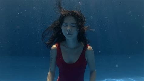 Young Woman Trying To Hold Her Breath Underwater In Pool Stock Video