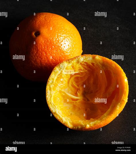 Used Orange Skins With Dramatic Light On Black Background Square Image