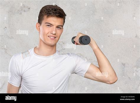 Funny Weak Man Tries To Lift A Weight Stock Photo Alamy