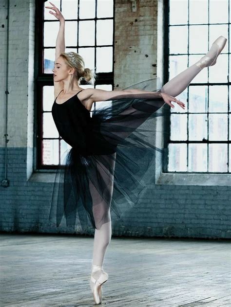A Ballerina In Black Is Posing For The Camera