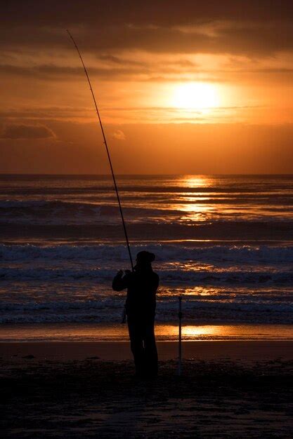 Premium Photo Silhouette Man Fishing In Sea Against Sunset Sky