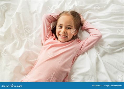 Happy Little Girl Lying In Bed At Home Stock Photo Image Of Relaxing