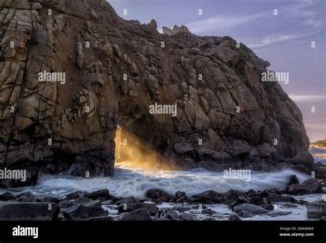 The Setting Sun Shining Through Keyhole Arch At Pfeiffer Beach Big Sur