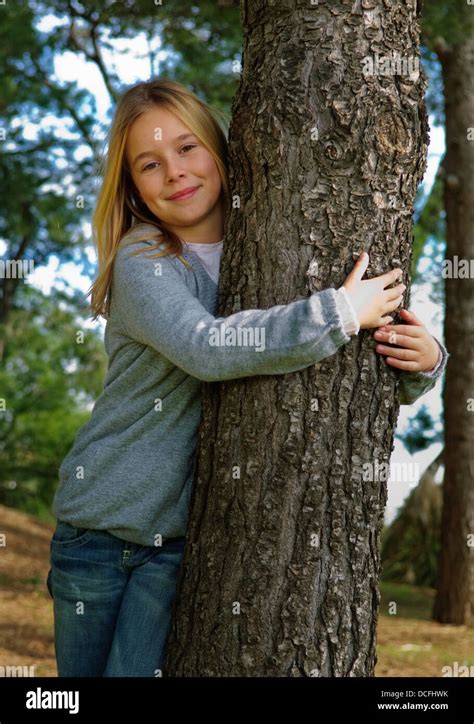 Young Girl In The Woods Hugging A Tree Stock Photo Alamy