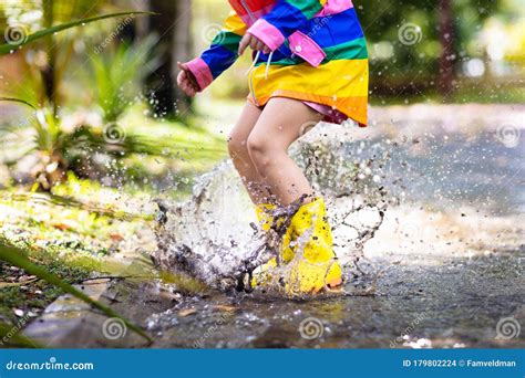 Kids In Puddle In Autumn Rain Waterproof Wear Stock Photo Image Of