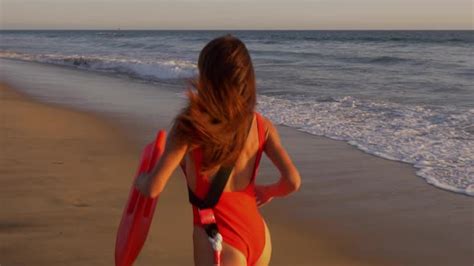 Female Lifeguard Running Along The Beach Stock Footage Videohive